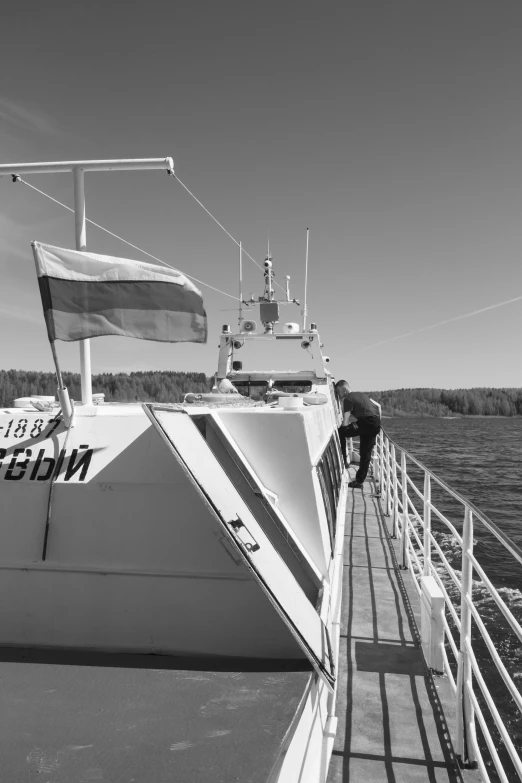 a boat traveling on a lake near a shore line