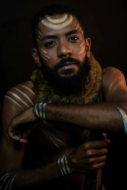 man with painted eyebrows and an indian headdress