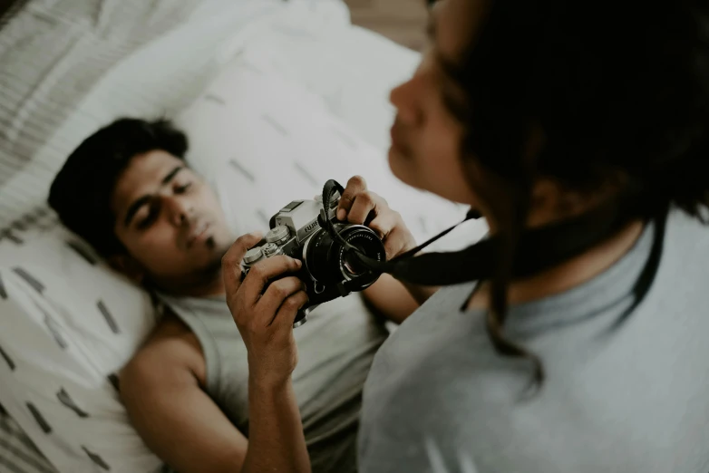 woman looking at man laying on bed in mirror