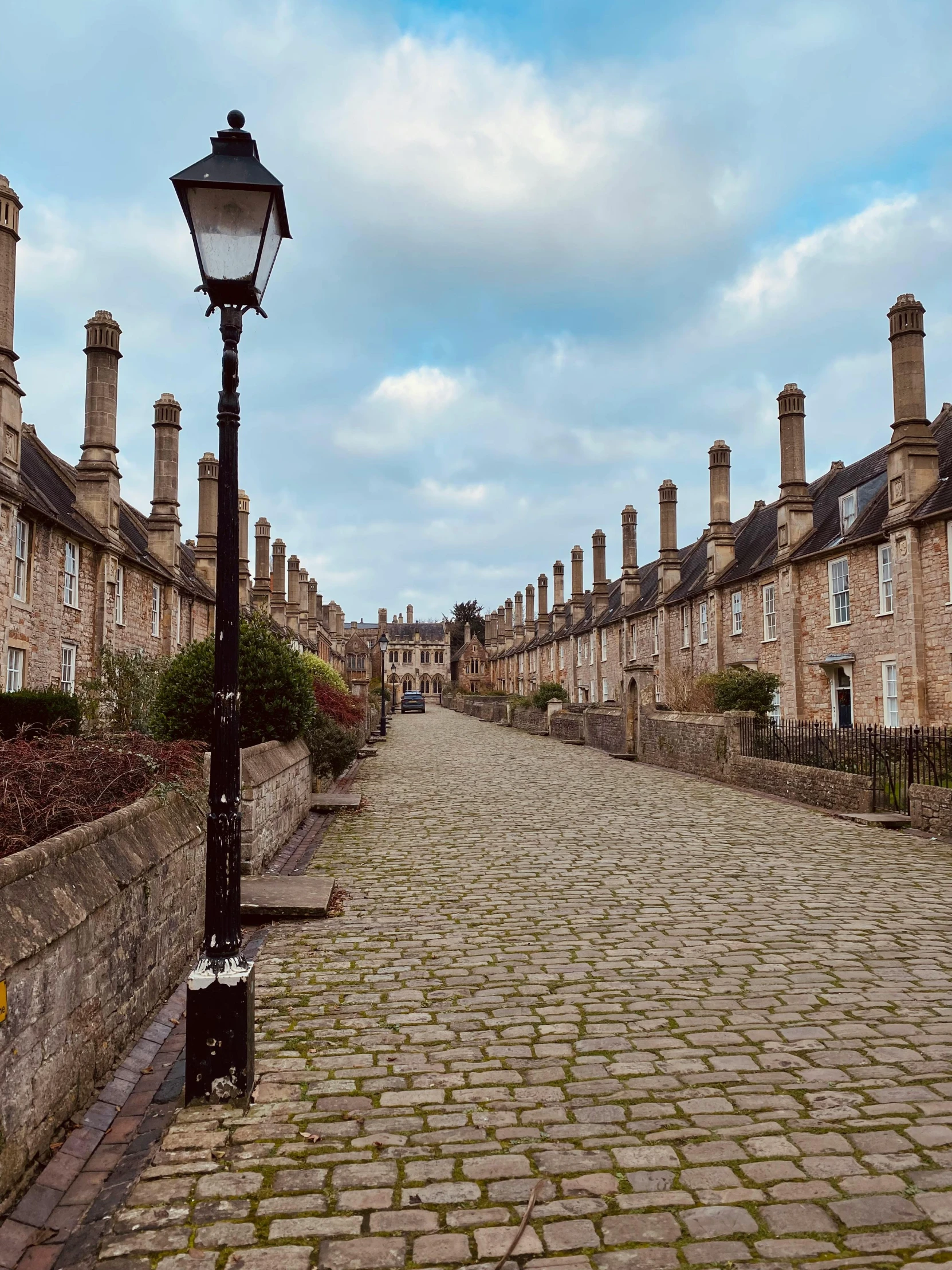 a brick street that is empty and some buildings