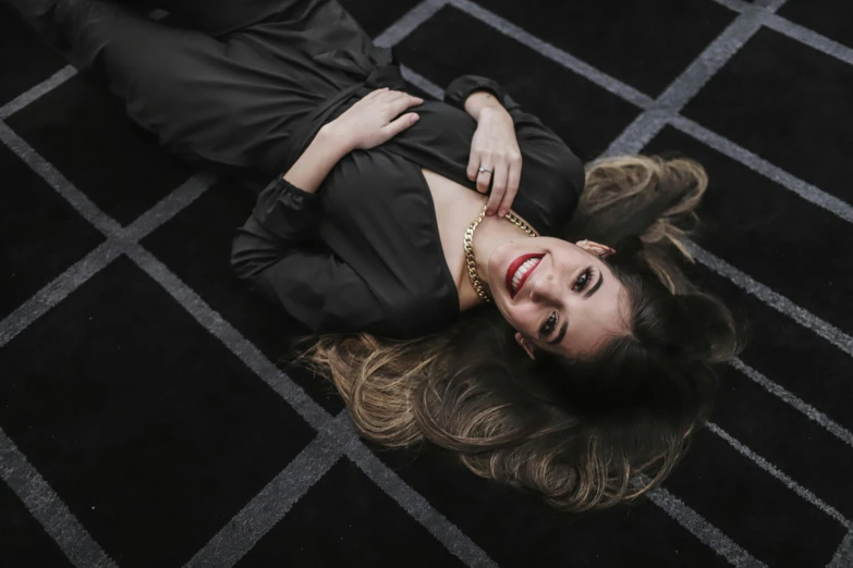 a woman laying on the floor with her head propped up