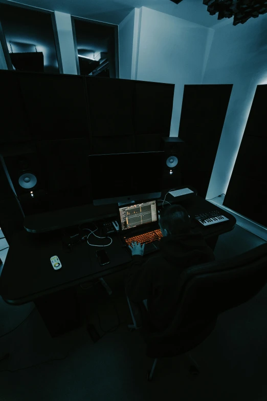 a table with electronic equipment in a dimly lit room