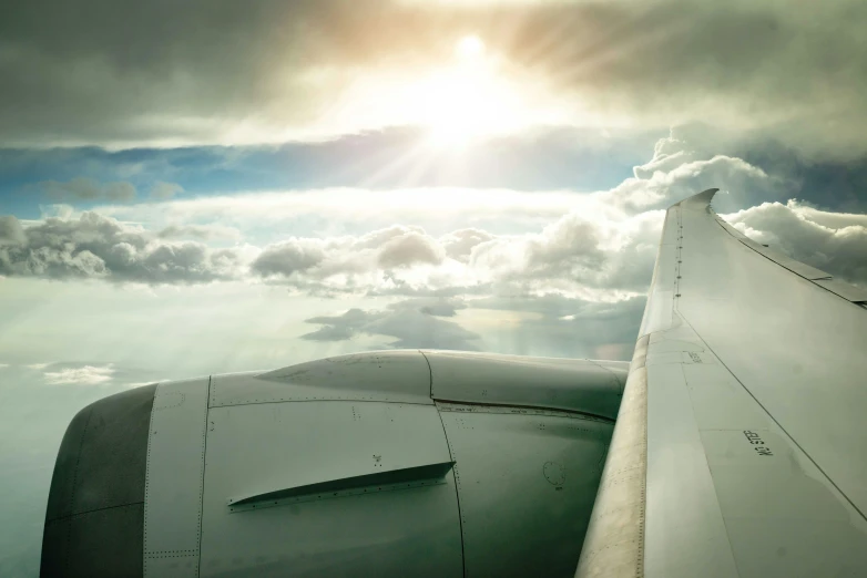 the view of a wing with a bright sky in the background