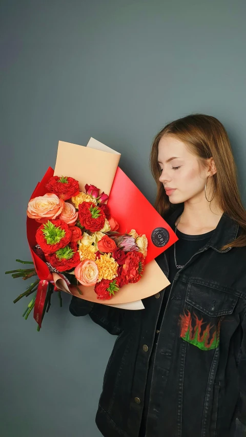 the woman in a black jacket is holding up a bouquet of roses