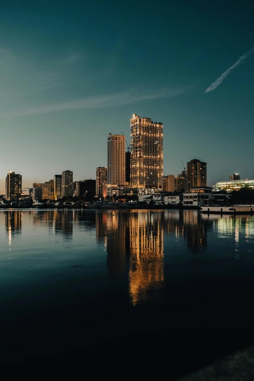 a large body of water with buildings behind it