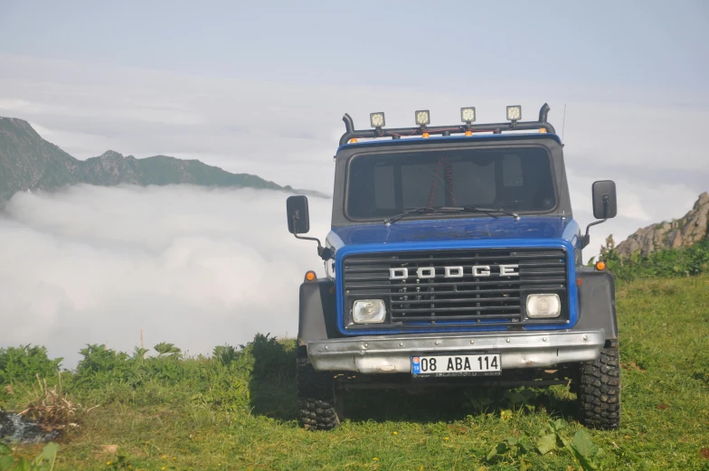a large truck with mountains in the background