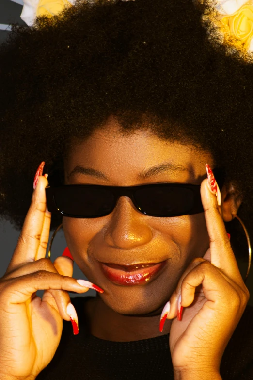 a young black woman with afro and dark sunglasses