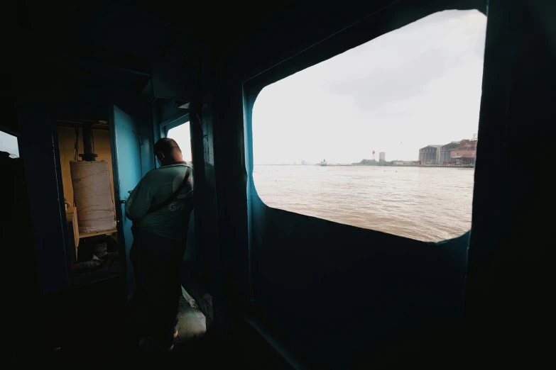 a person is standing on a ship with the ocean view