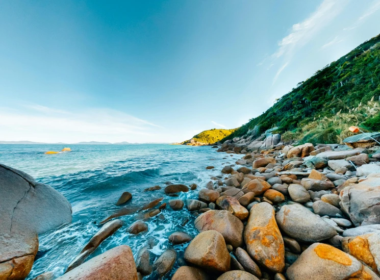 several rocks in the water near the shore