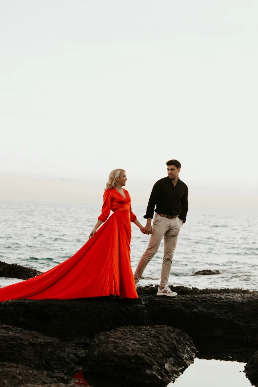 two people walking by the water holding hands