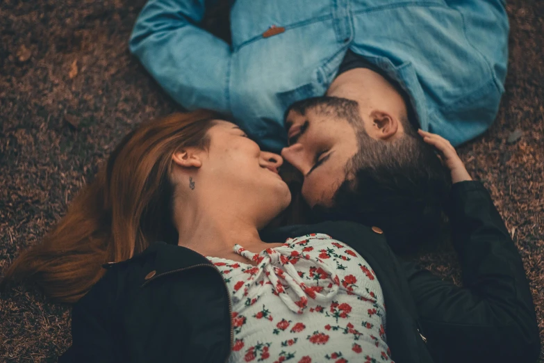 a couple sleeping on the ground together