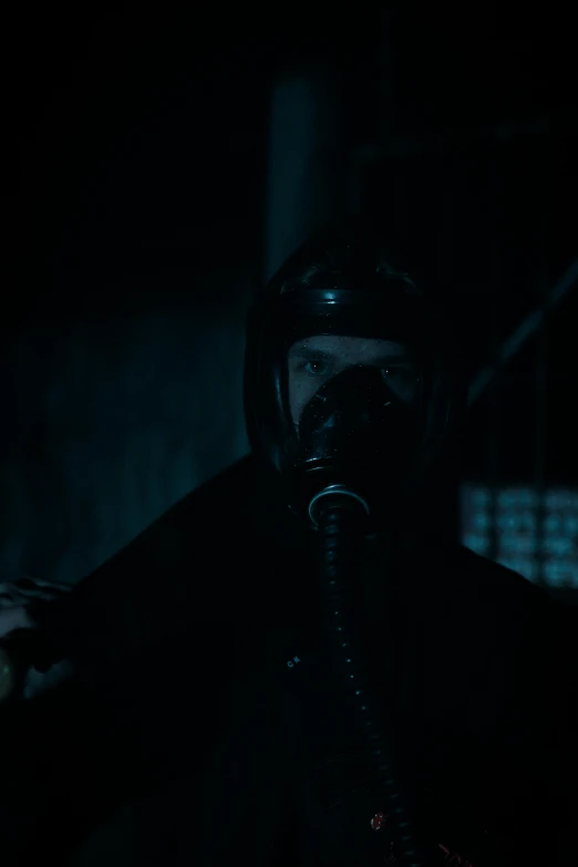 a man wearing a gas mask is smoking in the dark