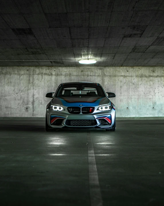 a car parked in a parking garage underneath a light