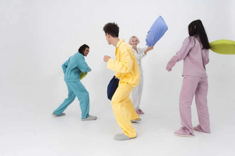 a man in yellow pajamas holding up blue cloths