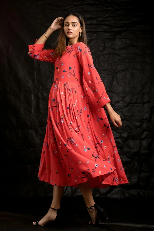 a woman is posing for a picture in a red dress