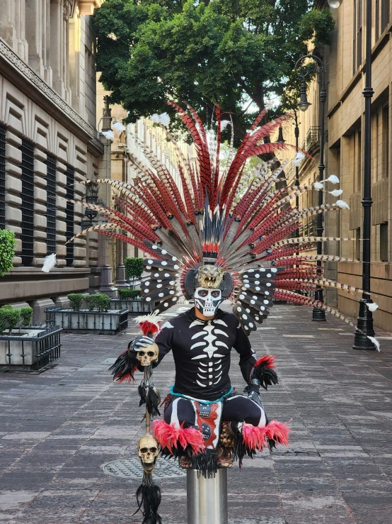 a sculpture depicting an individual wearing feathers and headdress