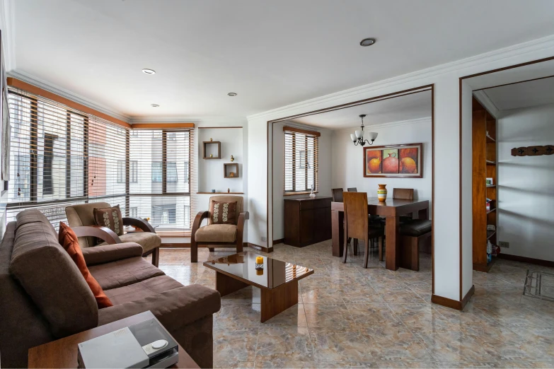 a living room with brown couches and white walls