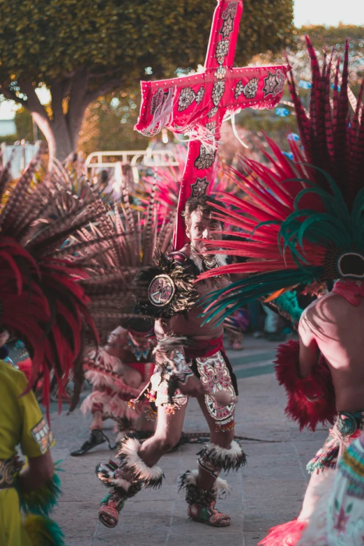 a woman in colorful costumes and headdress walking