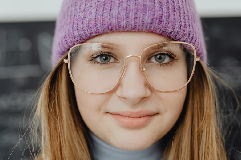 a close - up s of a young woman with glasses