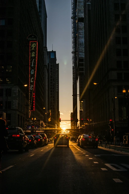 a city road that is covered in traffic at sunset