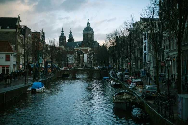 a waterway is lined with boats and people