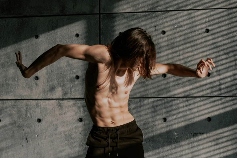 the young man is leaning against a wall