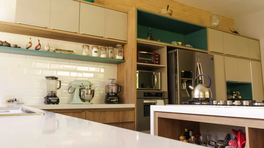 a kitchen filled with lots of open shelves and a silver refrigerator