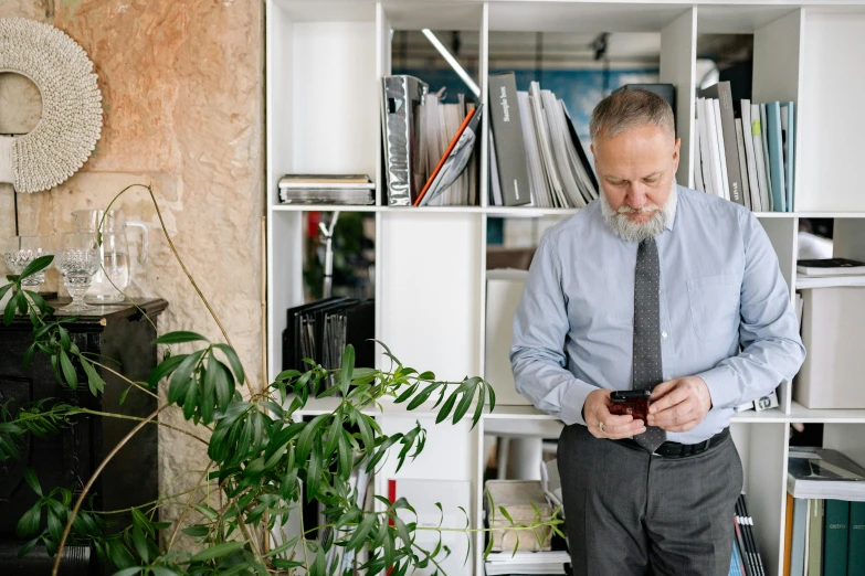 a man with a tie standing in a room