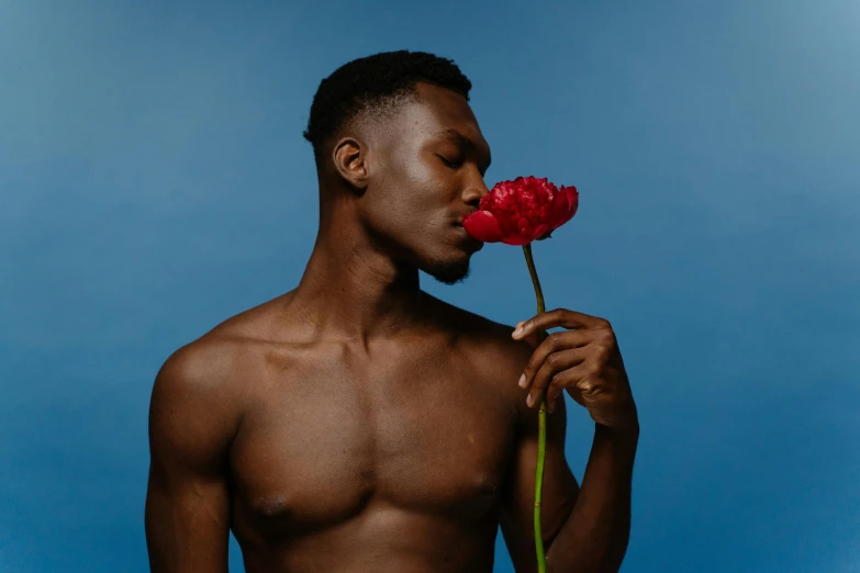 man with  standing in front of a flower