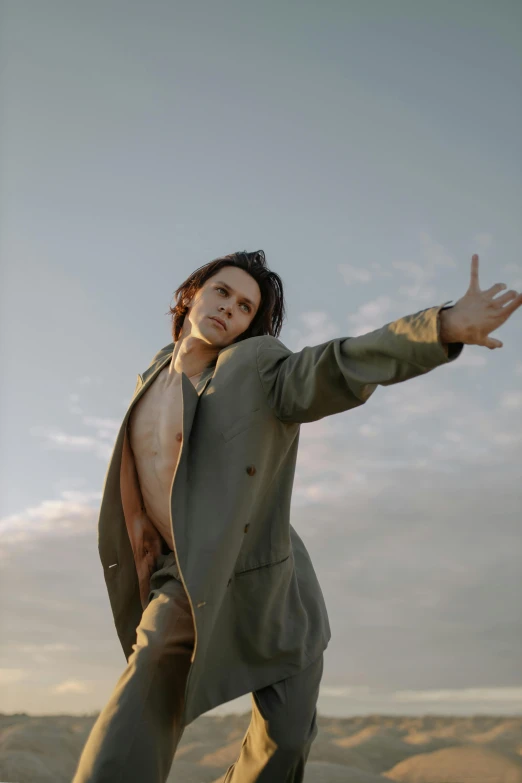 a man wearing a jacket is jumping and smiling