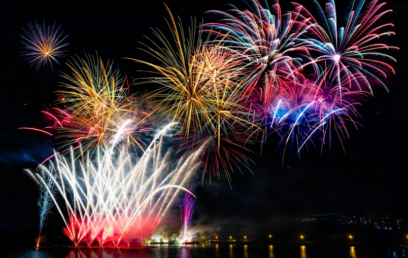 a view of fireworks at night from across the water