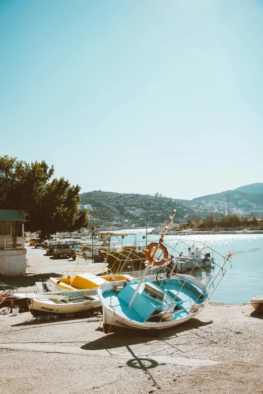 two boats sit on the shore in the sand