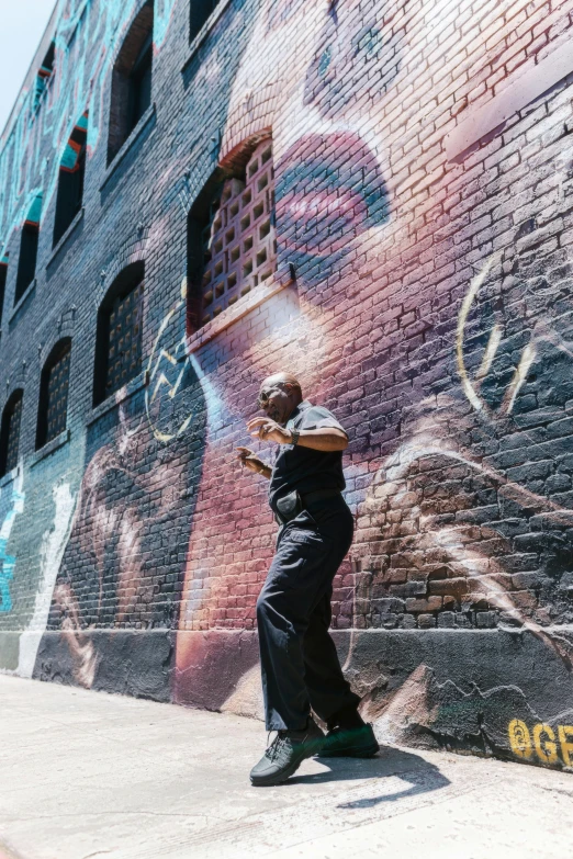 a man is painting on the side of a wall