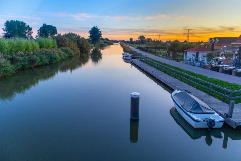 some boats moored next to each other at sunset