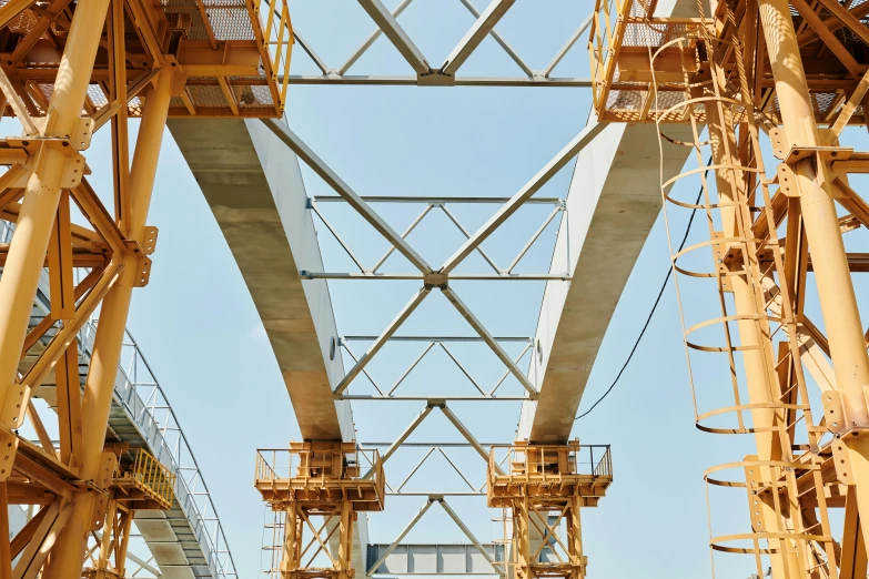 a yellow overhead structure is under a blue sky