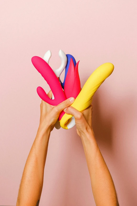 a hand holding up a bunch of plastic colorful objects