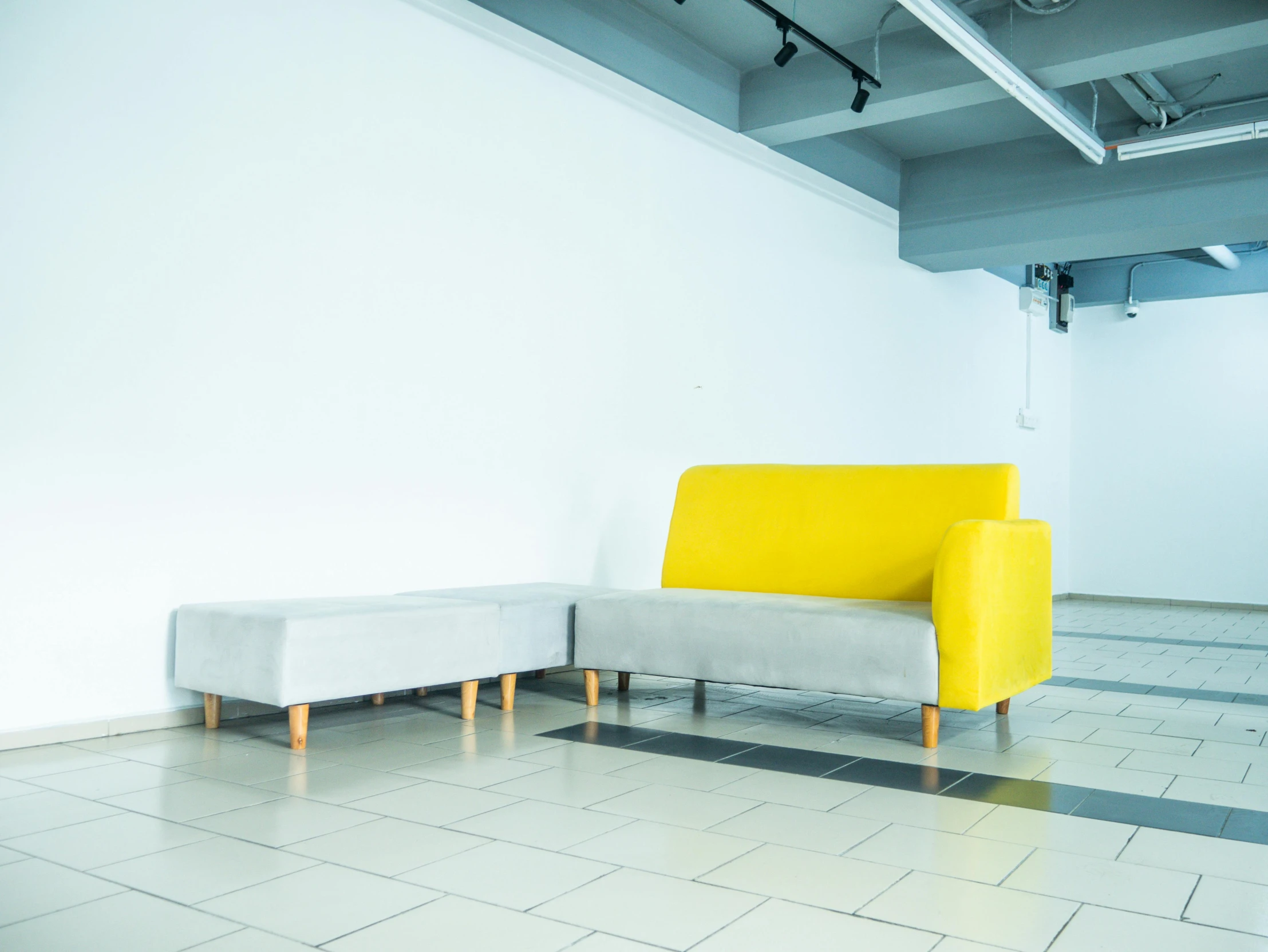 yellow chair and gray couch in white room