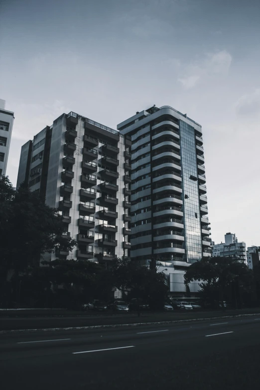 a black and white po of skyscrs and road