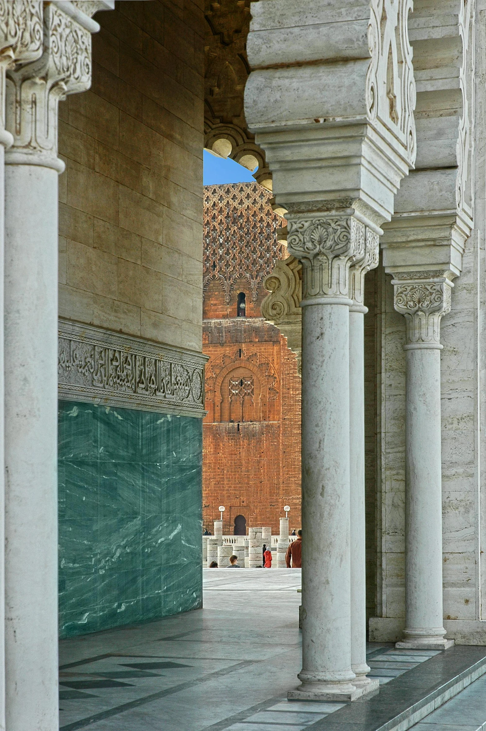 a brick wall and columns in a courtyard