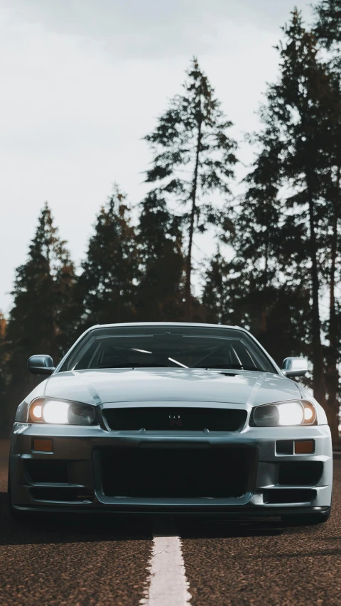 car driving on the road next to a forest