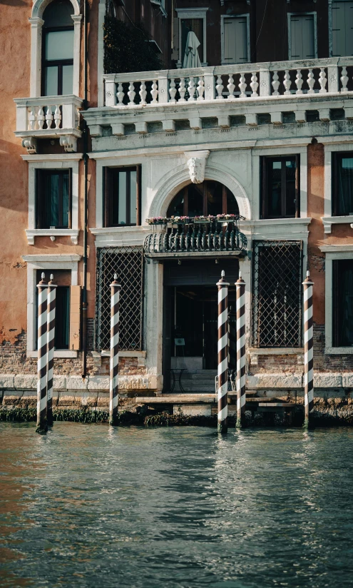 a building with columns by the water