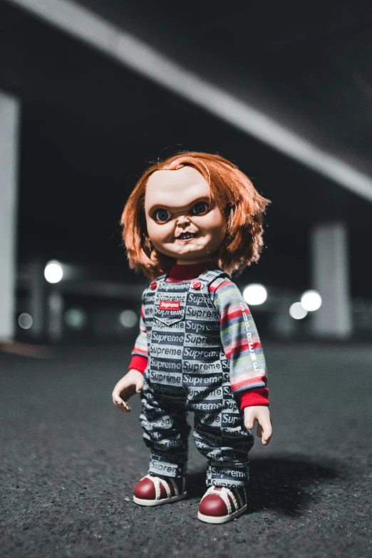 a creepy doll with red hair and glasses on