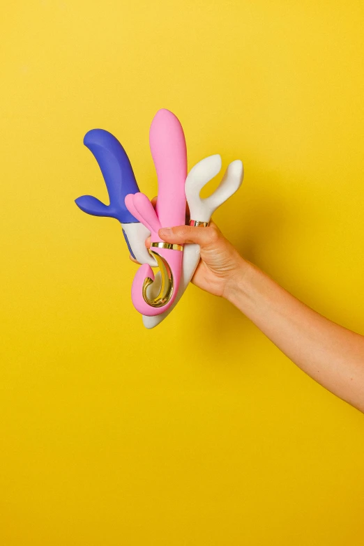 a person holding a pair of scissors made of plastic