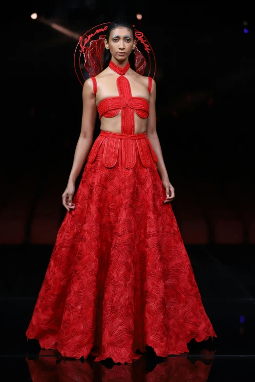 a red dress is on the catwalk for a show