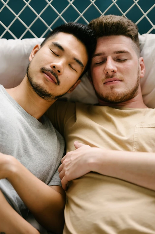 two men laying down next to each other