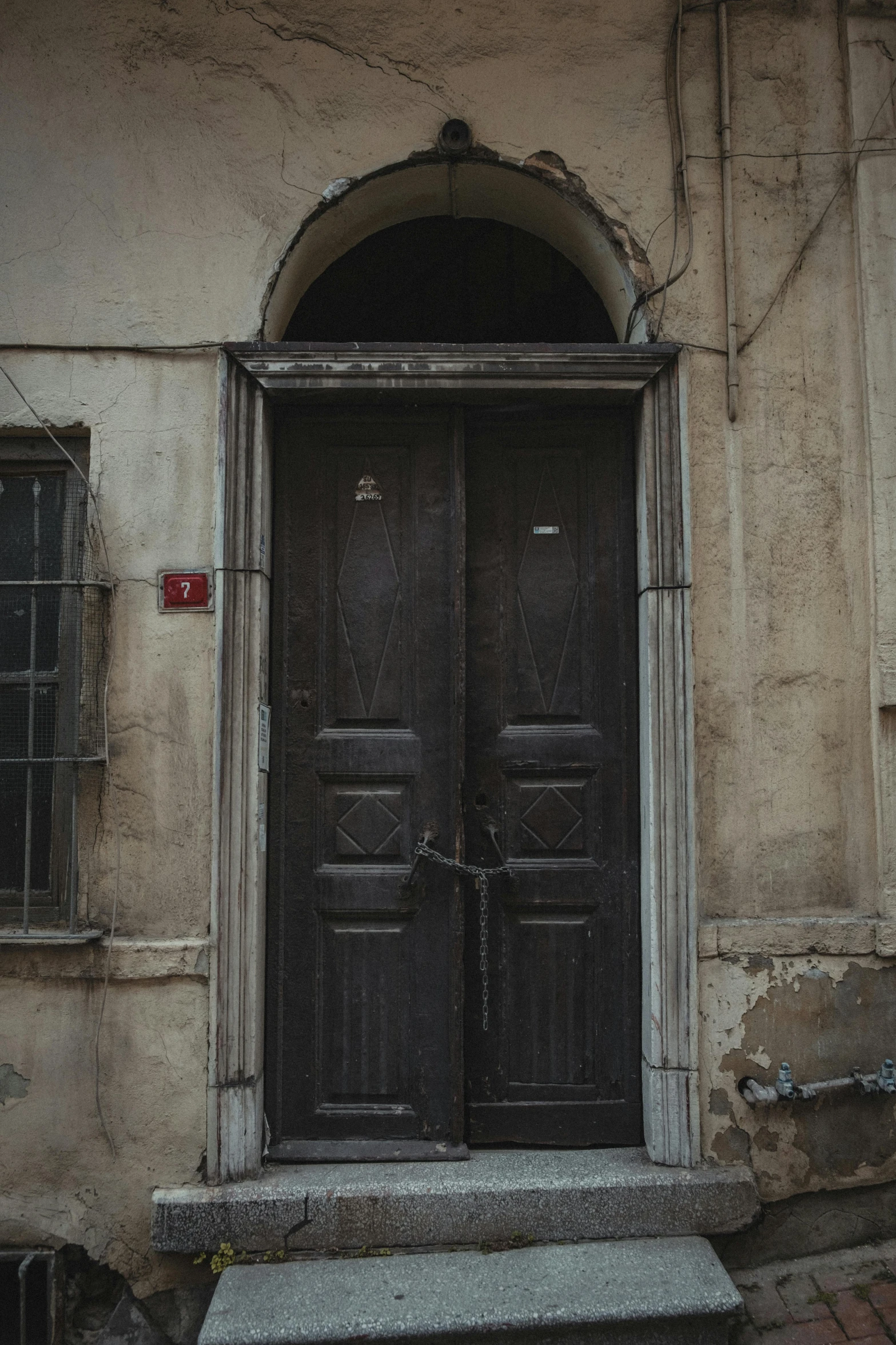 two double doors are on the side of a building