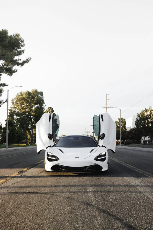 an exotic car is parked on the side of the road