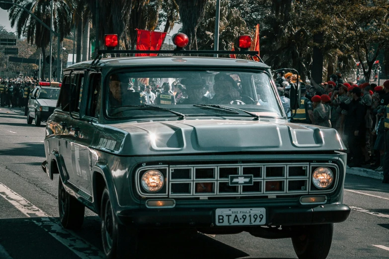 a military vehicle in a parade with people watching