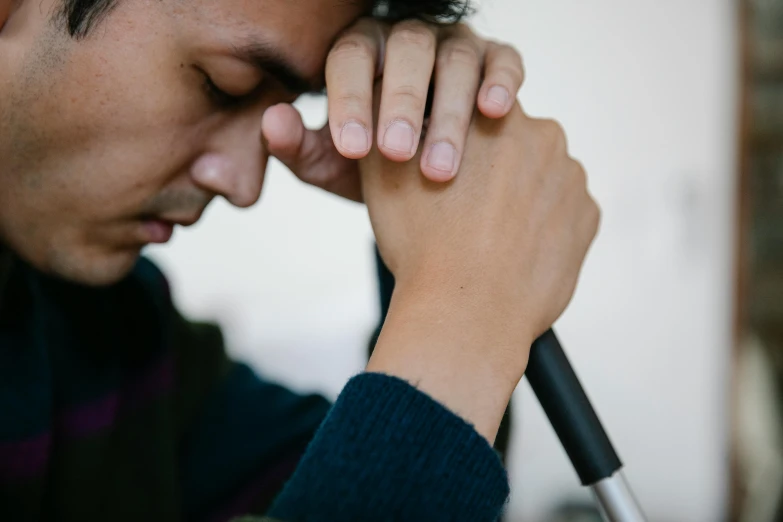 a close up of a man holding a stick in his hand