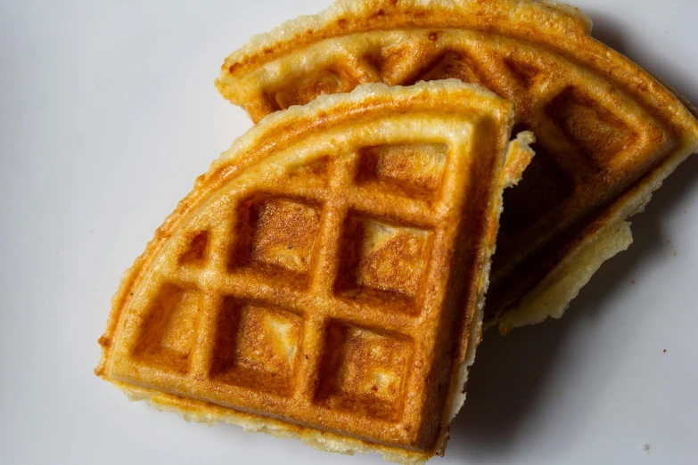 two waffle sandwiches sit together on a plate